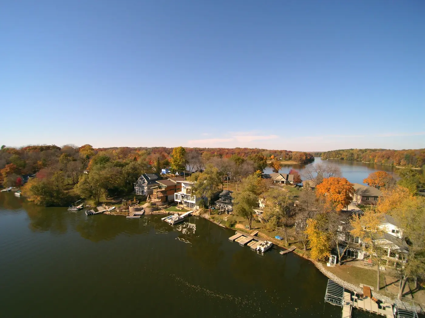 Aerial view of lakefront homes in fall foliage — drone survey for landscape planning