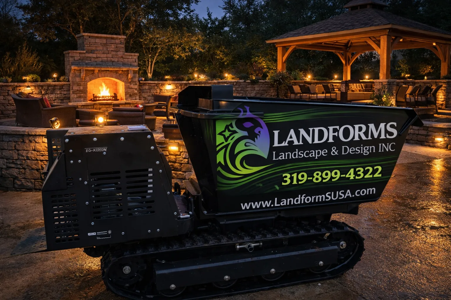 Landforms Design Inc equipment on completed stone patio with night lighting — Cedar Rapids Iowa 2026
