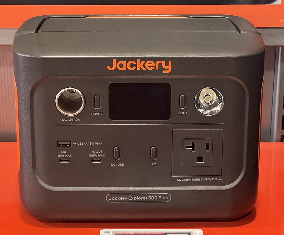 A dark gray Jackery Explorer 300 Plus power station with a display, USB ports and an AC outlet on the front